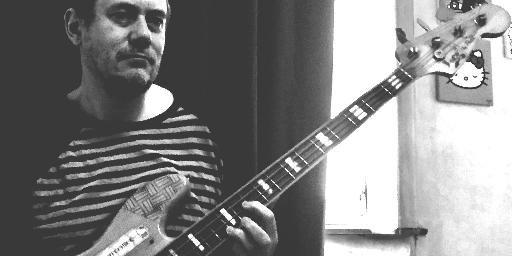 Belgian artist Gilles Snowcat practices bass guitar during the COVID19 Lockdown
