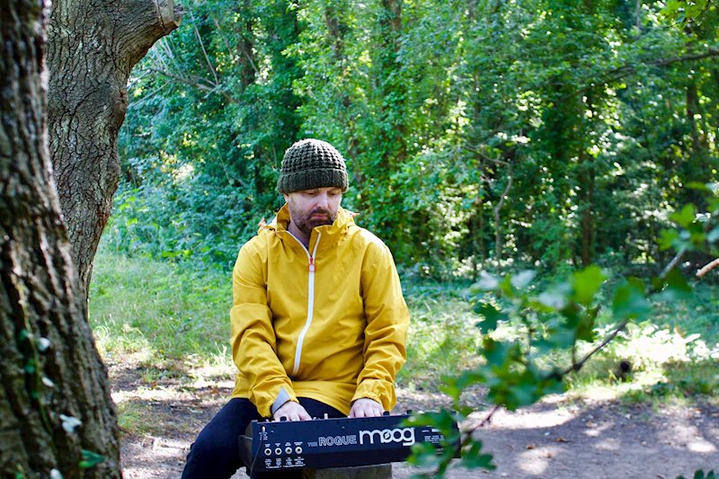 Photo of Rodney Cromwell in woods with Moog Rogue. Photo by Alison Ahern.
